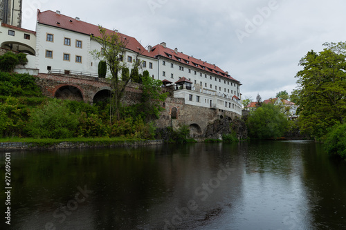 Panoramic landscape view on river Vltava in the historic city of Cesky Krumlov with famous Church city is on a UNESCO World Heritage Site captured during spring with nice sky and clouds