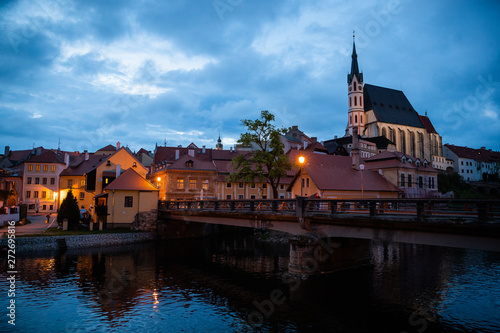 Panoramic landscape sunset view with blue dark sky the historic city of Cesky Krumlov with famous Church city is on a UNESCO World Heritage Site captured during spring with nice sky and clouds © Lukas