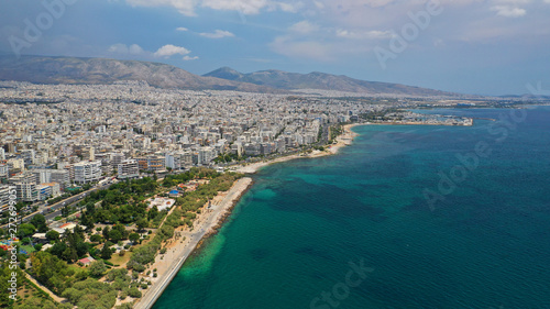 Aerial panoramic photo of famous seaside bay of Faliro with beautiful emerald sea, clouds and deep blue sky © aerial-drone