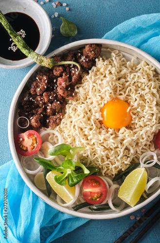 Chinese noodles with beef, vegetables and eggs. Asian cuisine. Ramen with meat. Traditional Chinese food photo