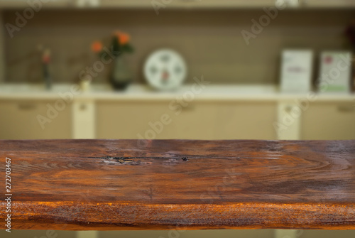 A wooden board on the background of the kitchen. An empty product board. Sharpness in the foreground. Empty space for goods.