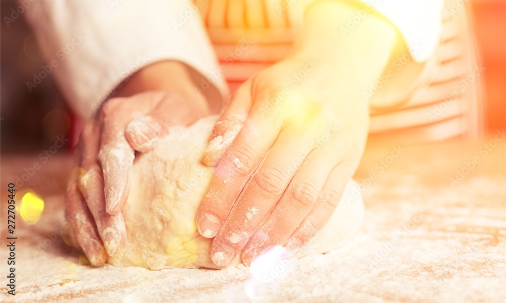 Woman's hands knead the dough close up Woman's hands knead the dough close up