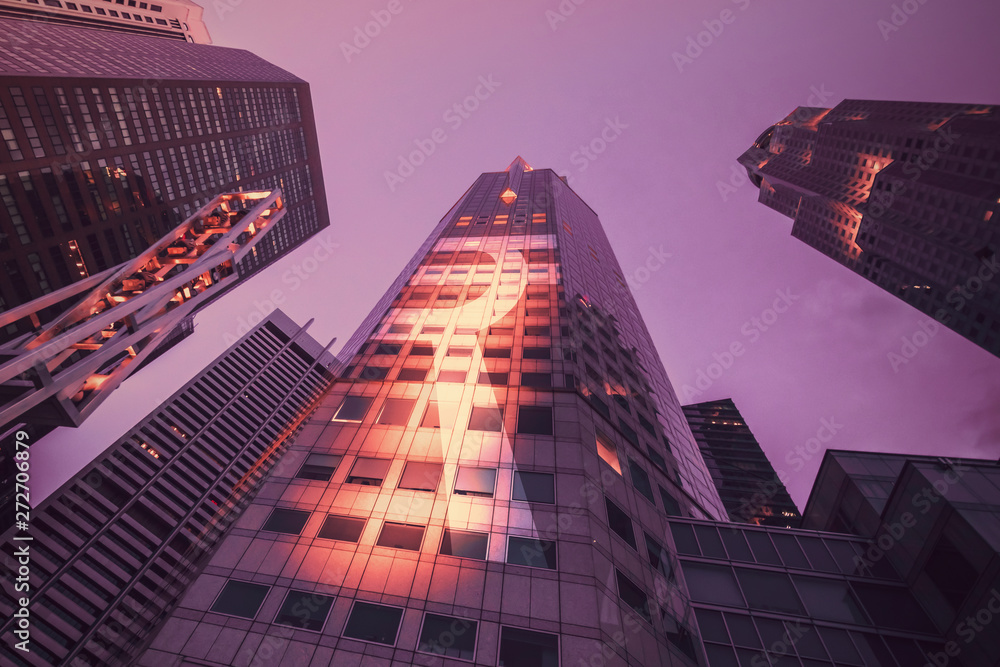 Bottom view of modern skyscraper in the twilight. Business district