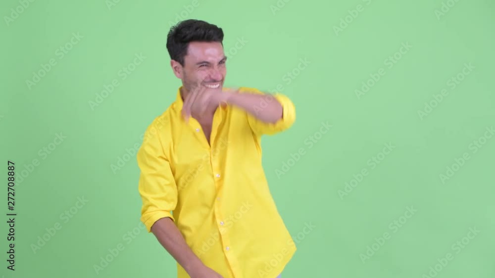 Happy young Hispanic businessman looking around and feeling excited Happy young Hispanic businessman looking around and feeling excited