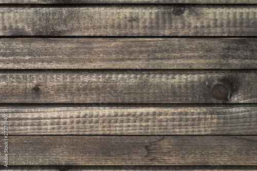 brown horizontal boards. Wooden textured background. Dark brown vintage background from a variety of thick boards.