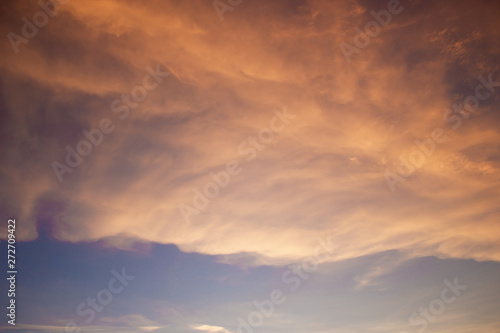 A BEAUTIFUL SUNSET SKY WITH ORANGE AND YELLOW CLOUDS WITH BLUE SKY