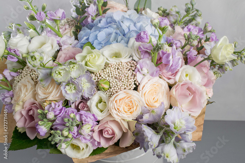 delicate  pastel coloured Small Beautiful bouquet of mixed flowers. Floral shop concept . Beautiful fresh cut bouquet. Flowers delivery