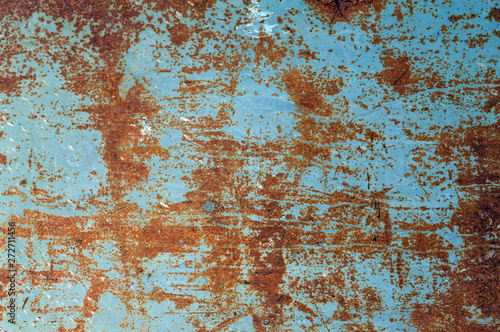 grunge background: rough painted metal sheet with lots of rust stains, scratches