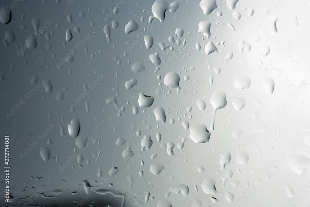 Abstraction of droplets on glass in the rain in shades of gray Abstraction of droplets on glass in the rain in shades of gray