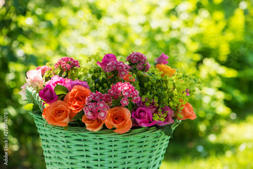 Basket with many colorful summer flowers