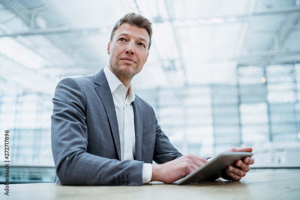 Businessman using tablet at table Businessman using tablet at table