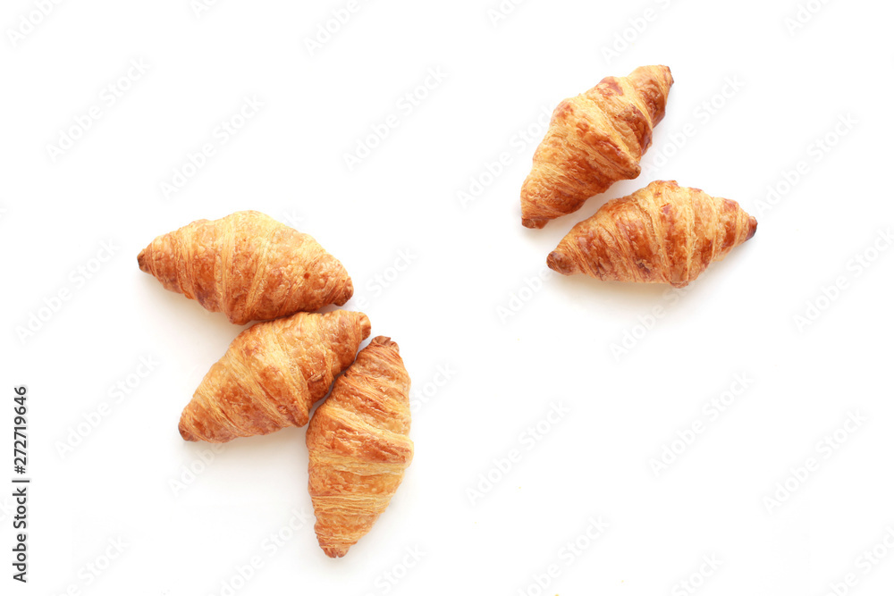 Fototapeta premium Five freshly baked tasty crusty croissants isolated on white.