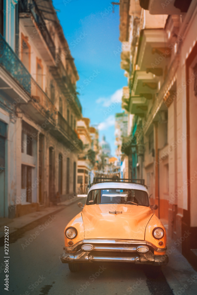 Antique car on a narrow street in Old Havana