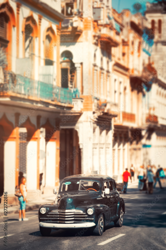Fototapeta premium Colorful buildings and a classic car in Old Havana