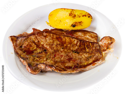 Beef steak with potatoes on a white plate