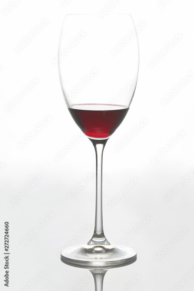 glass with red wine on a light background glass with red wine on a light background