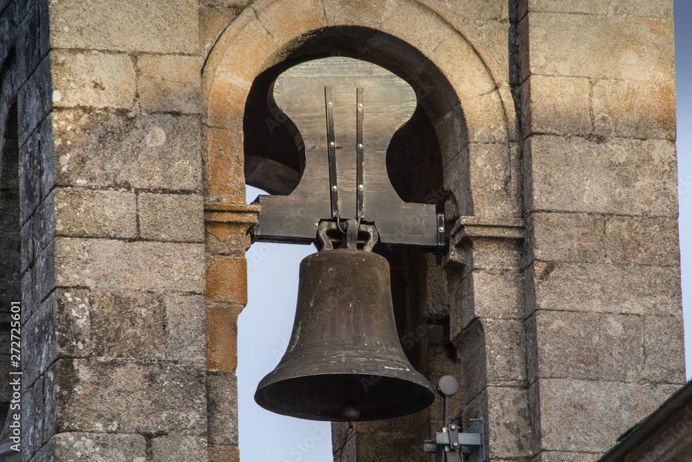 Ancient bell of a Spanish church in a bell tower in Spain, wooden and steel bell.