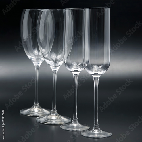 Four wine glasses on a dark background close-up