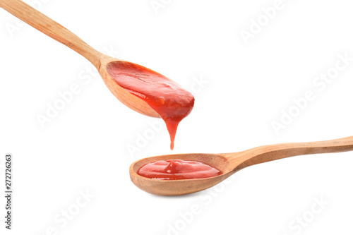 Spoons of tomato sauce isolated on white photo