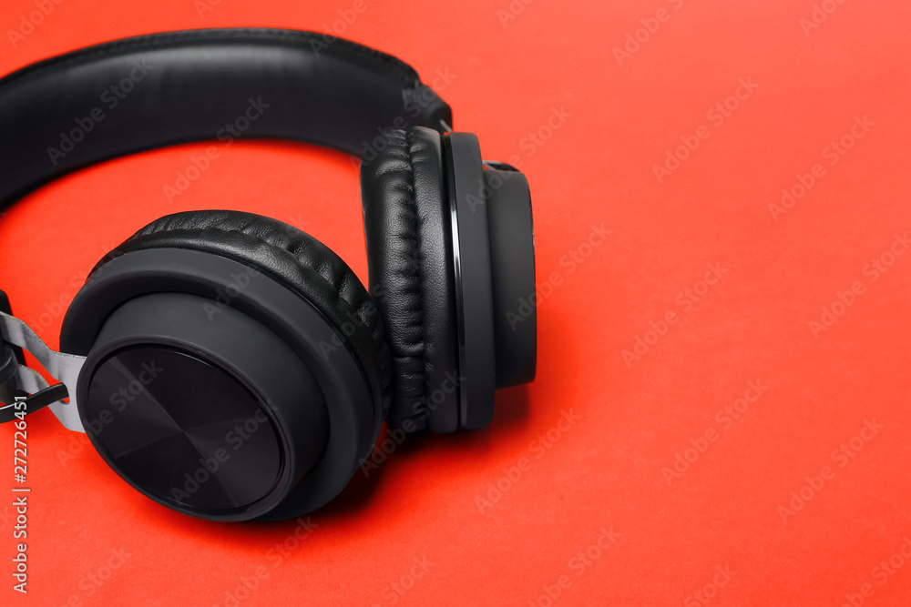Stylish headphones on color background, closeup. Space for text