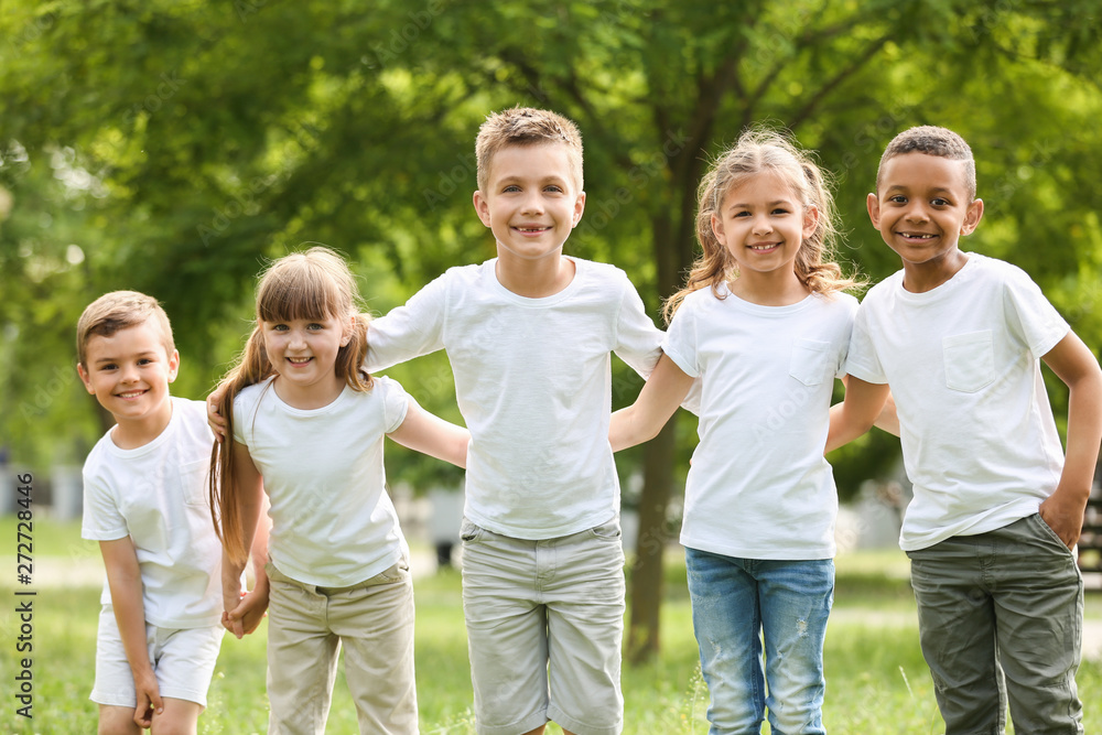 Group of children huddling in park. Volunteer project