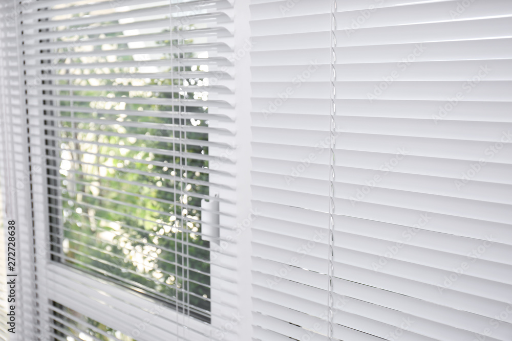 Window with closed white horizontal blinds as background Window with closed white horizontal blinds as background