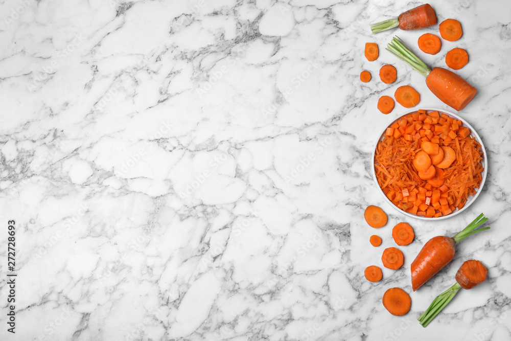 Flat lay composition with cut carrot on marble background. Space for text Flat lay composition with cut carrot on marble background. Space for text