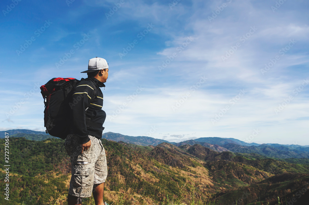 Traveler Man with backpack mountains landscape on background.