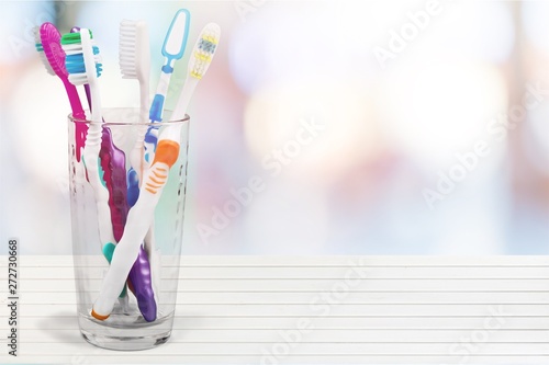 New Colorful Toothbrushes in A Glass  on  Background