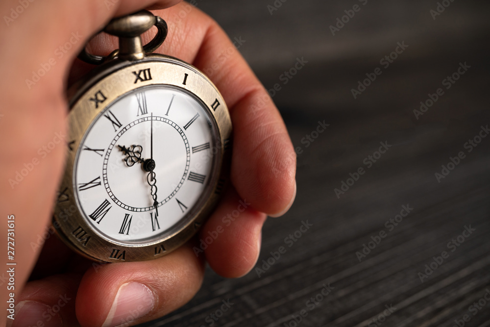 Men hands hold a pocket watch and a black background. Men hands hold a pocket watch and a black background.