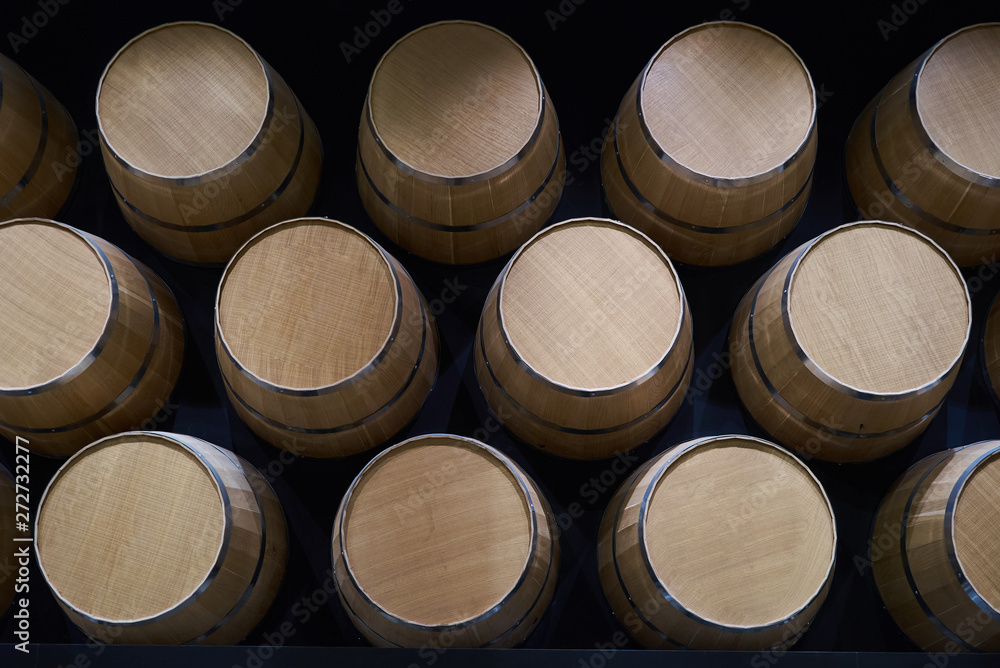 Wine barrels in wine-vaults in order, close-up. Stacked wine barrels Wine barrels in wine-vaults in order, close-up. Stacked wine barrels