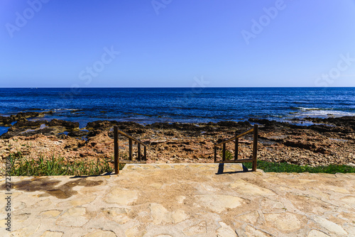 Background of a path that leads to the beach with a deep blue sky color.