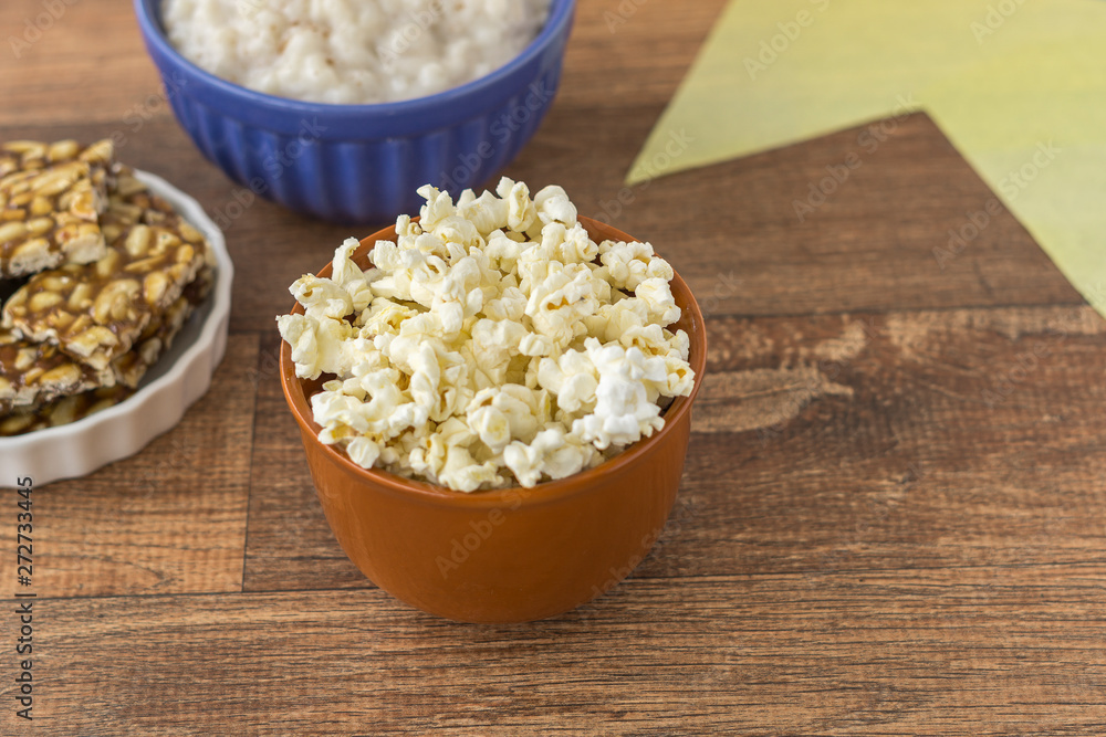 Ceramic bowl with popcorn on gray background Ceramic bowl with popcorn on gray background