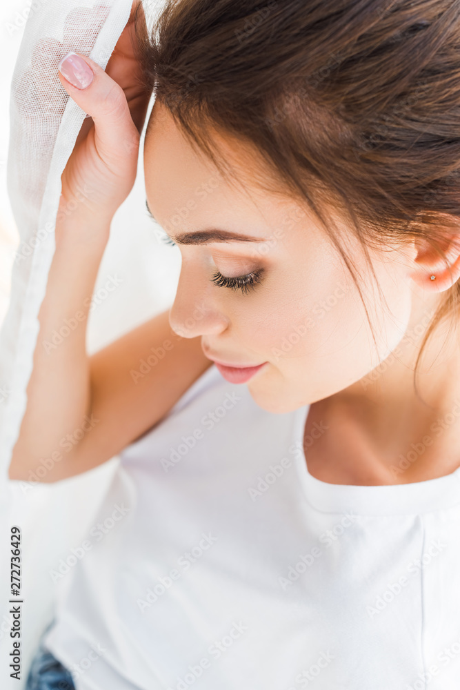 overhead view of pretty young woman in white t-shirt overhead view of pretty young woman in white t-shirt