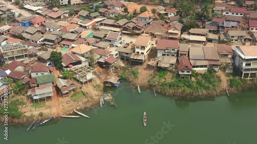 View from above, stunning aerial view of a traditional long tail boat with tourists on board sailing on the Nam Ngum River to the Thalat village.  Luang Prabang, Laos. photo