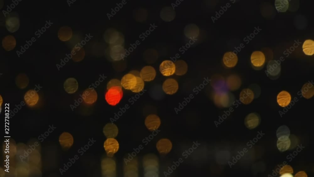 Cinematic abstract shot of city lights defocussed at night. Beautiful bokeh with glimmering colours of orange, blue, white, gold and purple Shot on Canon C100 with L-Series Lenses. Cinematic abstract shot of city lights defocussed at night. Beautiful bokeh with glimmering colours of orange, blue, white, gold and purple Shot on Canon C100 with L-Series Lenses.