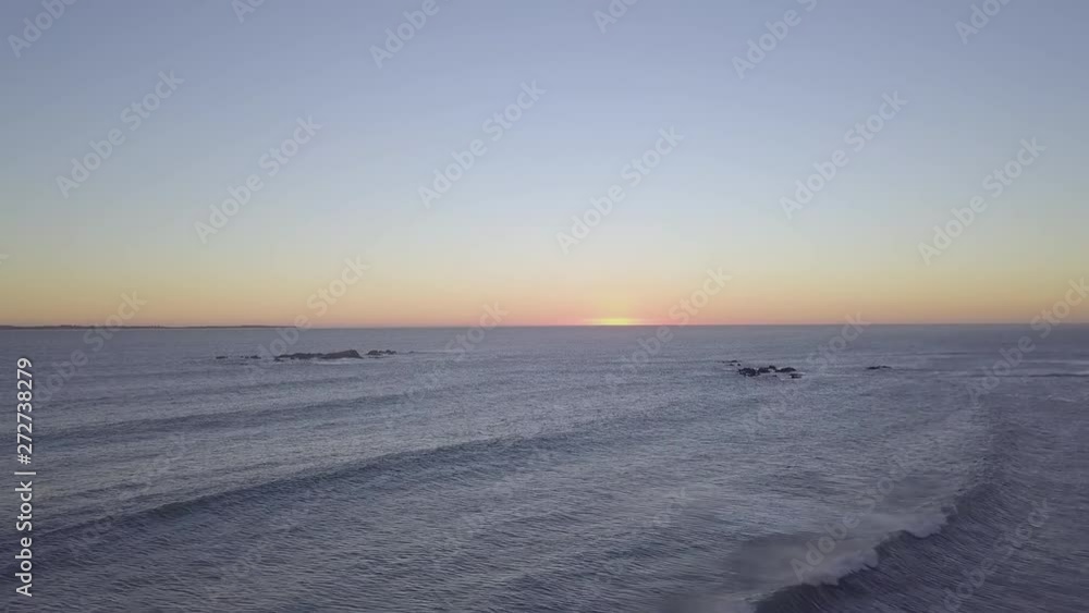 Cinematic wide shot fast jib up over sea and waves from drone from Big Bay, Blouberg on a perfect sunset in Cape Town, South Africa