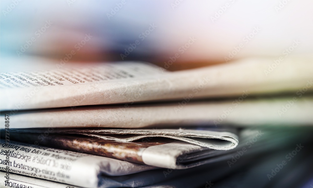 Fototapeta premium Pile of newspapers on background close up