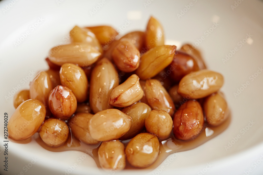 Pickled peanut on white dish Pickled peanut on white dish