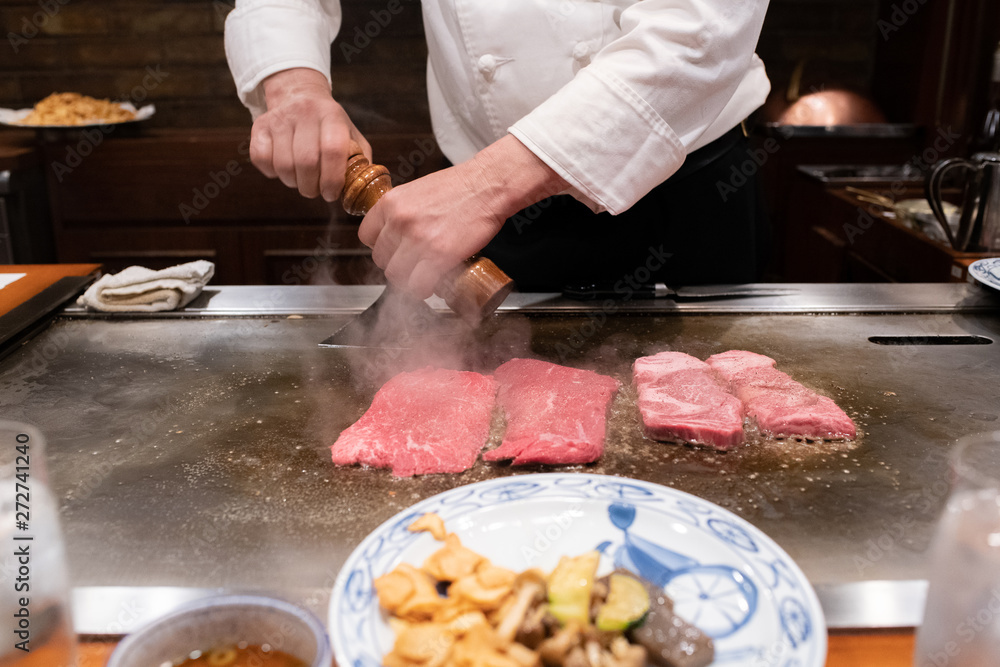 The chef is cooking a Japanese food style steak.