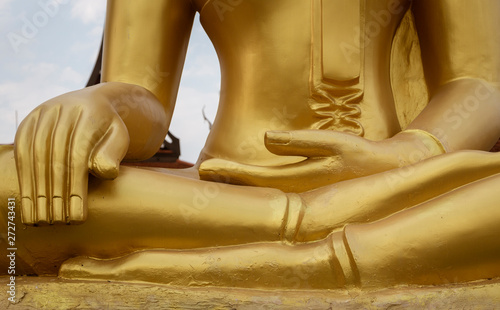 Closeup of hands of Golden Buddha Statue.