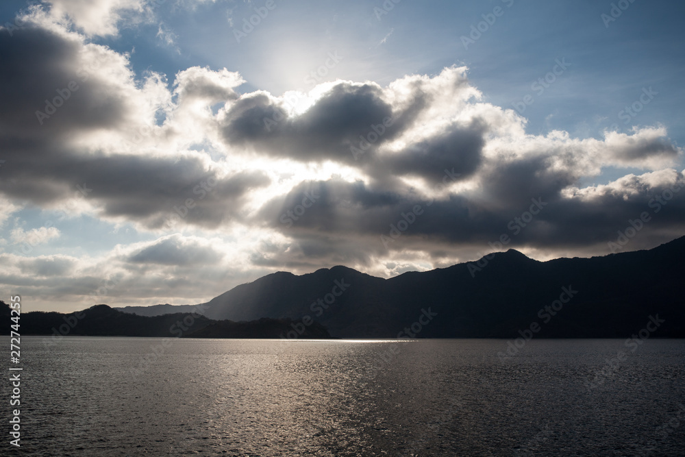Beams of late afternoon sunlight illuminate the dramatic, volcanic hills surrounding Horseshoe Bay in Komodo National Park, Indonesia. Beams of late afternoon sunlight illuminate the dramatic, volcanic hills surrounding Horseshoe Bay in Komodo National Park, Indonesia.