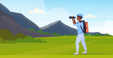 tourist hiker with backpack looking through binoculars hiking concept african american traveler on hike beautiful mountains nature landscape background full length flat horizontal vector illustration