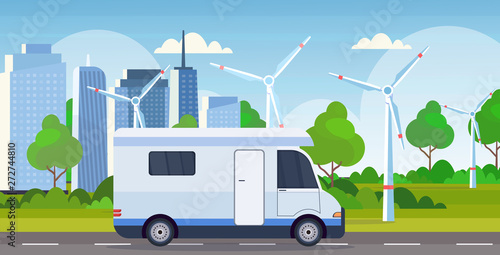 caravan car family trailer truck driving on road recreational travel vehicle camping concept wind turbines cityscape background flat horizontal