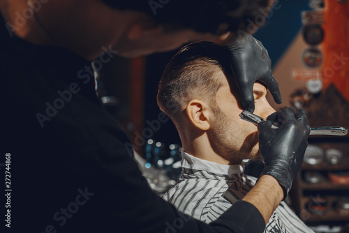 Man with a beard. Hairdresser with a client.