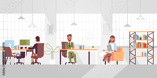 corporate staff employees working in creative co-working open space coworkers businesspeople sitting at workplace and discussing new project modern office interior flat full length horizontal
