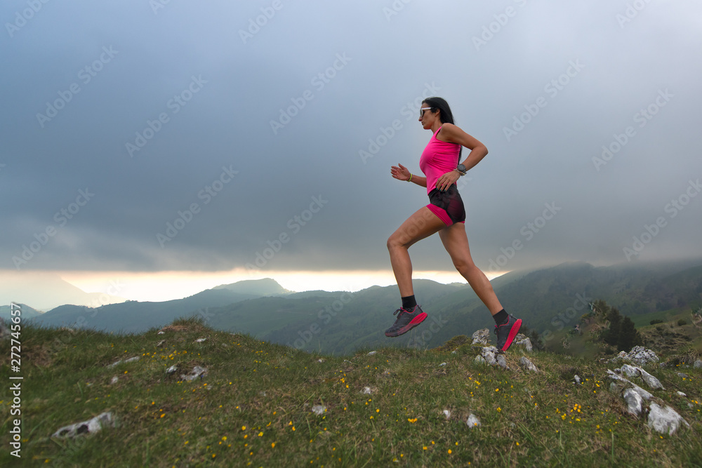 Trail running in the hills. A woman athlete Trail running in the hills. A woman athlete
