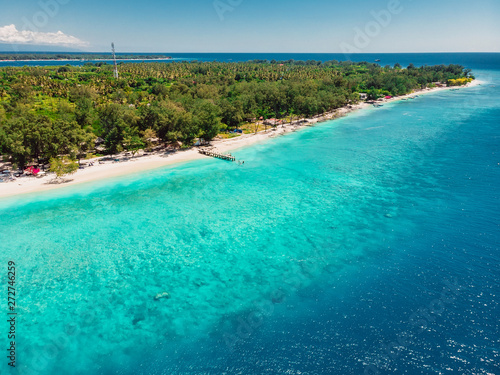 Tropical beach with white sand and turquoise ocean. Aerial view. Paradise holiday resort