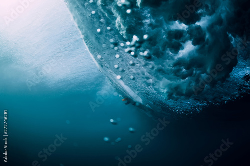 Underwater wave with air bubbles. Barrel wave crashing in ocean.