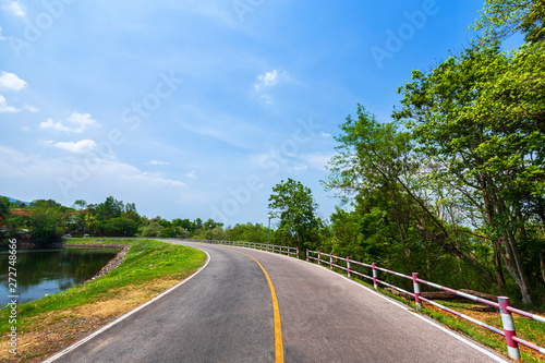 road view reservoir green tree with green nature forest in the hill and blue sky background.